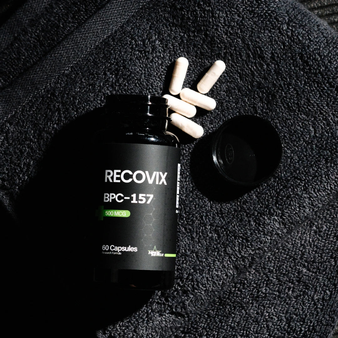Heroic Muscle Recovix BPC-157 supplement bottle with capsules on a textured black workout towel