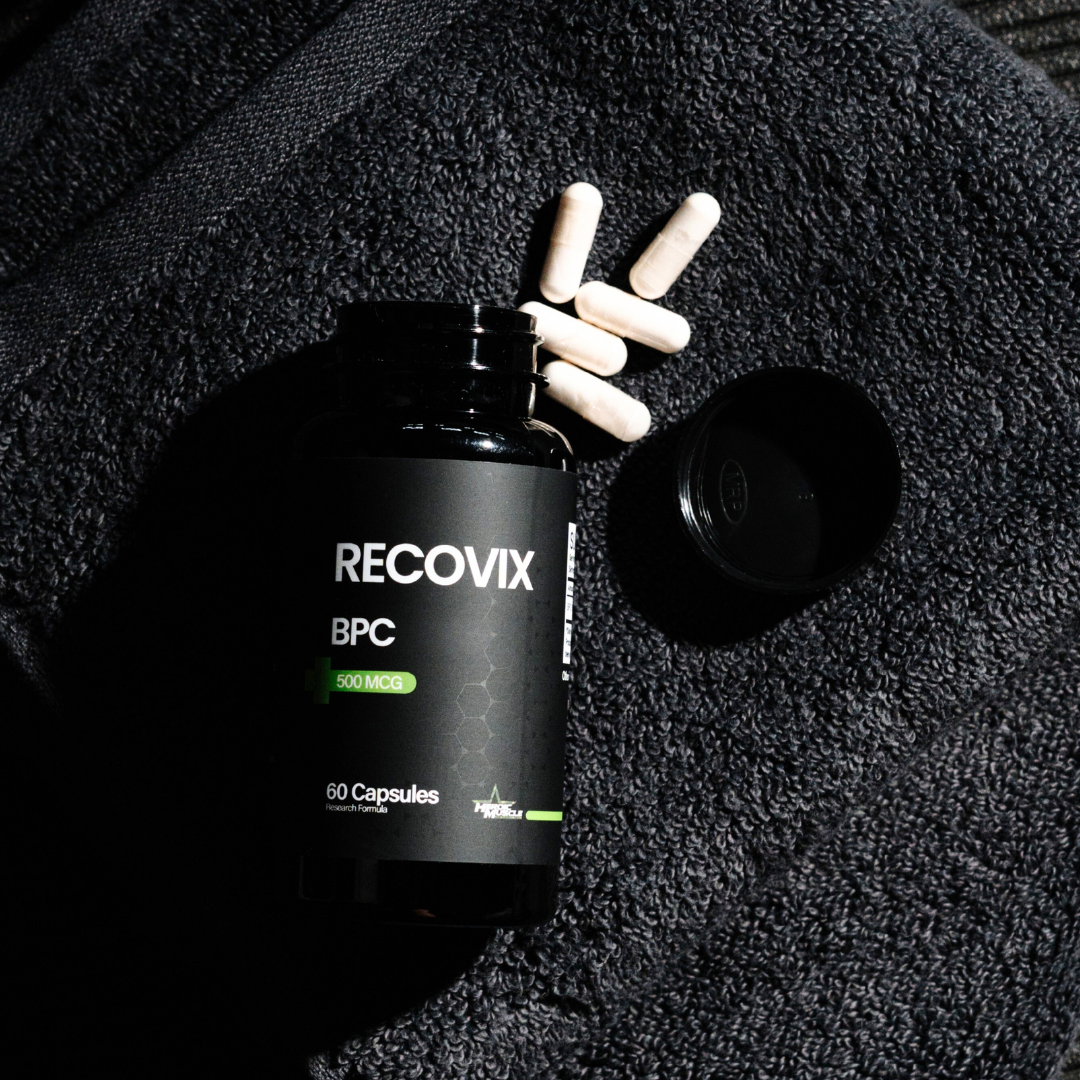 Heroic Muscle Recovix BPC supplement bottle with capsules on a textured black workout towel
